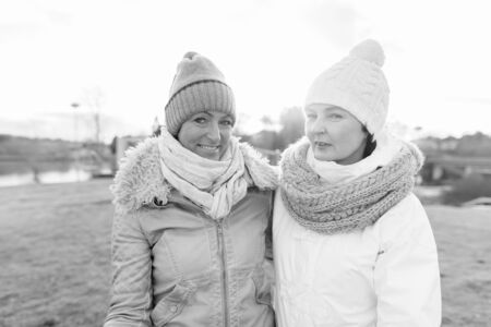 Two mature beautiful women together against scenic view of natureの写真素材