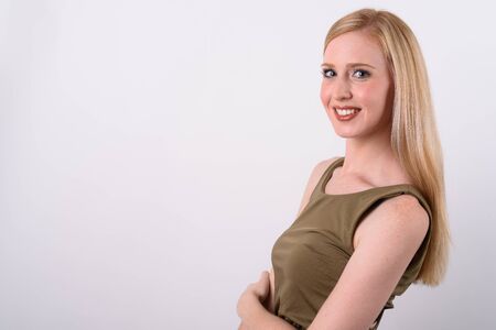 Young beautiful British woman with blond hair against white backgroundの写真素材