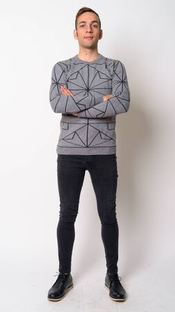 Full body shot of young Persian man with arms crossedの写真素材