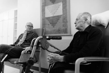 Mature man and senior man together at nursing home in Turku, Finland