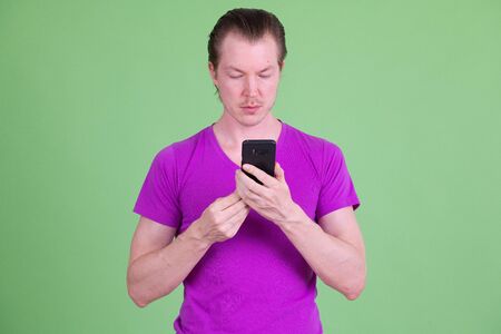 Portrait of young handsome man using phone