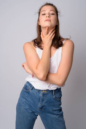 Portrait of young beautiful woman posing while holding neckの写真素材