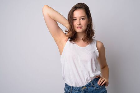 Portrait of young beautiful woman with hand on shoulderの写真素材