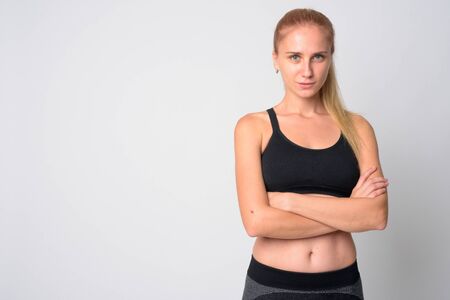 Portrait of young blonde woman with arms crossed ready for gymの写真素材