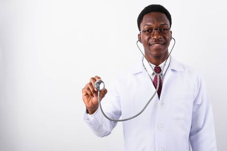 Young handsome African man doctor using stethoscope against whitの写真素材