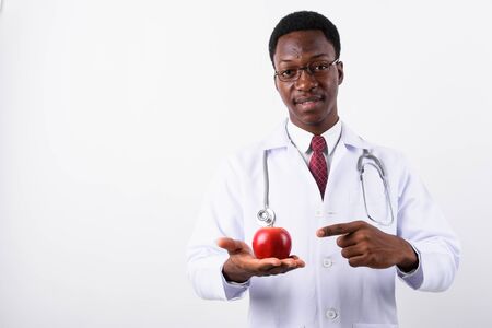 Young handsome African man doctor wearing eyeglasses against whiの写真素材