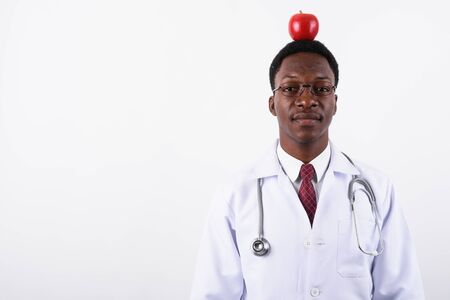 Young handsome African man doctor wearing eyeglasses against whiの写真素材