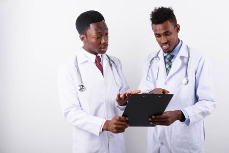 Two young African man doctors against white backgroundの写真素材