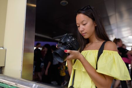 Young beautiful tourist woman exploring the city of Bangkok