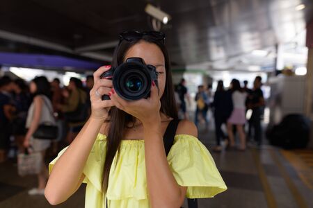Young beautiful tourist woman exploring the city of Bangkok