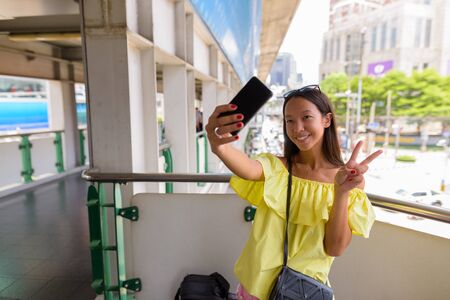 Young beautiful tourist woman exploring the city of Bangkokの写真素材