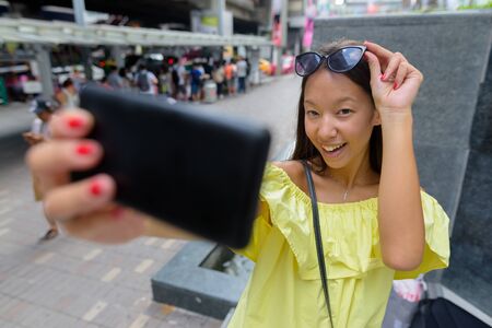 Young beautiful tourist woman exploring the city of Bangkok