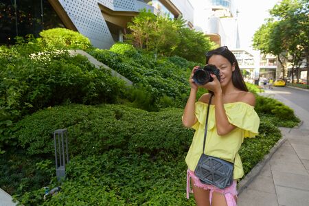 Young beautiful tourist woman exploring the city of Bangkok