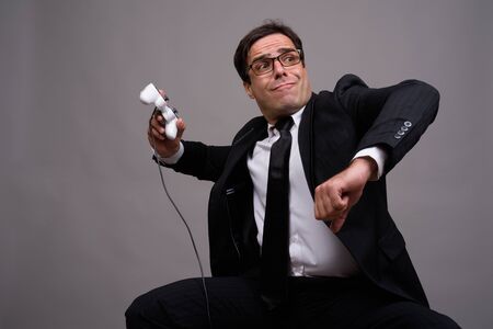 Portrait of Persian businessman in suit playing games