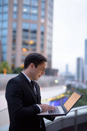 Handsome Persian businessman against view of the cityの写真素材