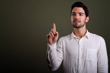 Portrait of young handsome businessman with stubble beard