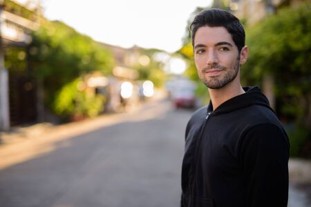 Young handsome man with stubble beard outdoors