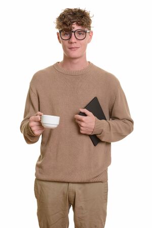 Young handsome Caucasian man holding book and coffee cupの写真素材