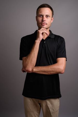 Portrait of handsome man against gray backgroundの写真素材