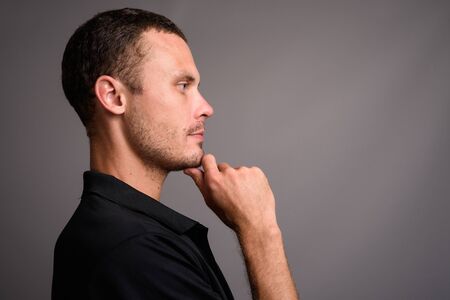 Portrait of handsome man against gray background