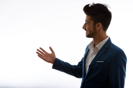 Young handsome bearded Persian businessman in suit