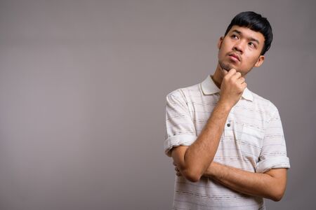 Portrait of young Asian man thinking and planningの写真素材
