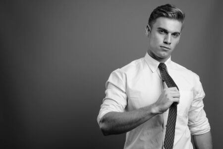 Portrait of young handsome businessman in black and whiteの写真素材