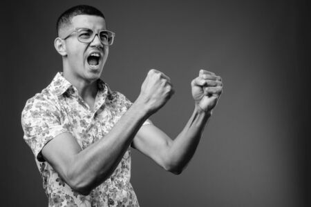 Young multi-ethnic Asian tourist man against brown backgroundの写真素材