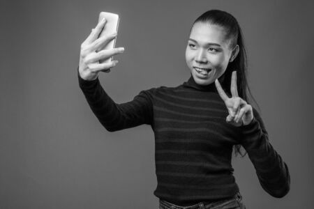Young beautiful Asian transgender woman in black and whiteの写真素材