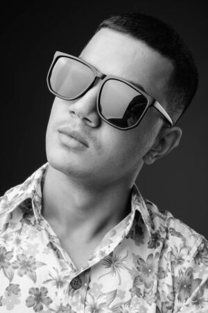 Young multi-ethnic Asian tourist man against brown backgroundの写真素材