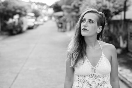 Young beautiful Hispanic tourist woman outdoors in black and whiteの写真素材