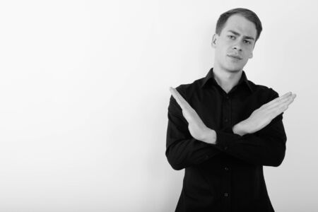 Portrait of young handsome businessman in black and whiteの写真素材