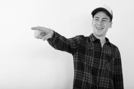 Young handsome hipster man wearing baseball cap in black and whiteの写真素材