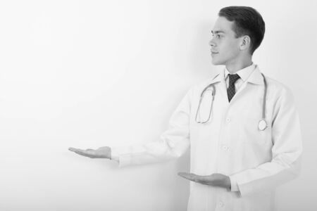 Portrait of young handsome man doctor in black and whiteの写真素材