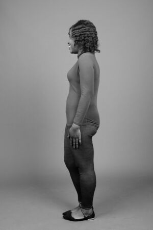 Young beautiful African woman against gray backgroundの写真素材