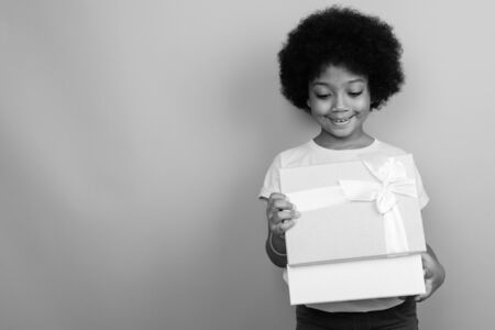 Young cute African girl with Afro hair in black and whiteの写真素材