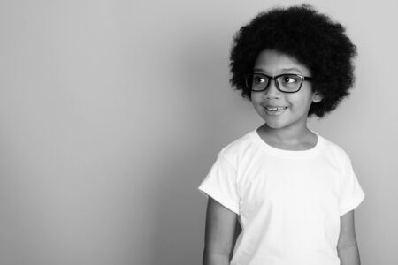 Young cute African girl with Afro hair in black and whiteの写真素材
