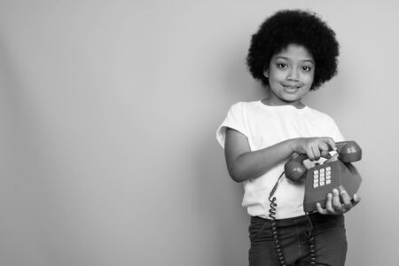 Young cute African girl with Afro hair in black and whiteの写真素材
