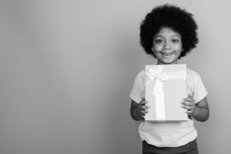 Young cute African girl with Afro hair in black and whiteの写真素材