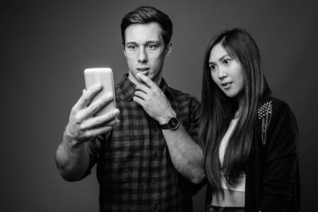 Portrait of young multi ethnic couple together in black and whiteの写真素材