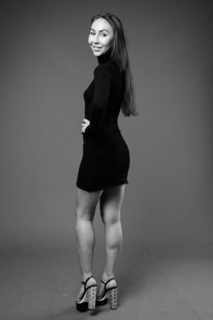 Studio shot of young beautiful businesswoman in black and whiteの写真素材