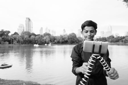 Portrait of young Indian boy relaxing at the park