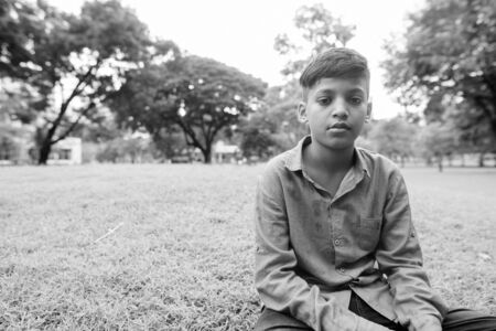 Portrait of young Indian boy relaxing at the parkの写真素材