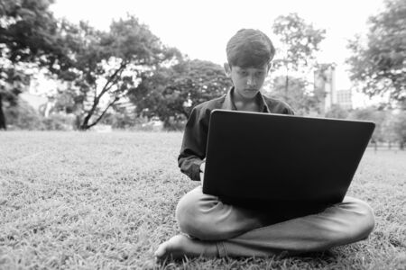 Portrait of young Indian boy relaxing at the parkの写真素材