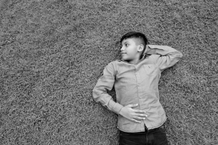 Portrait of young Indian boy relaxing at the park