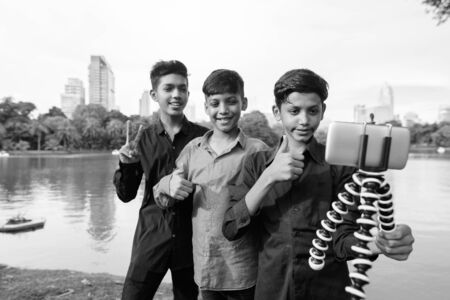 Portrait of Indian family relaxing together at the parkの写真素材