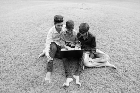 Portrait of Indian family relaxing together at the parkの写真素材