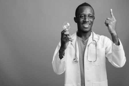 Young African man doctor with eyeglasses in black and whiteの写真素材