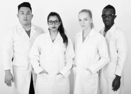 Studio shot of diverse group of multi ethnic doctors standing togetherの写真素材
