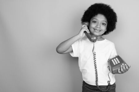 Young cute African girl with Afro hair in black and whiteの写真素材